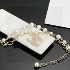 CHANEL - A FAUX PEARL CC BRACELET