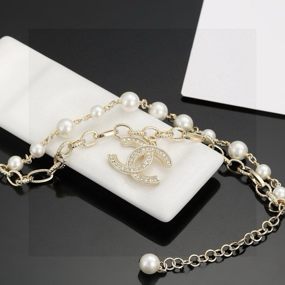 CHANEL - A FAUX PEARL CC BRACELET