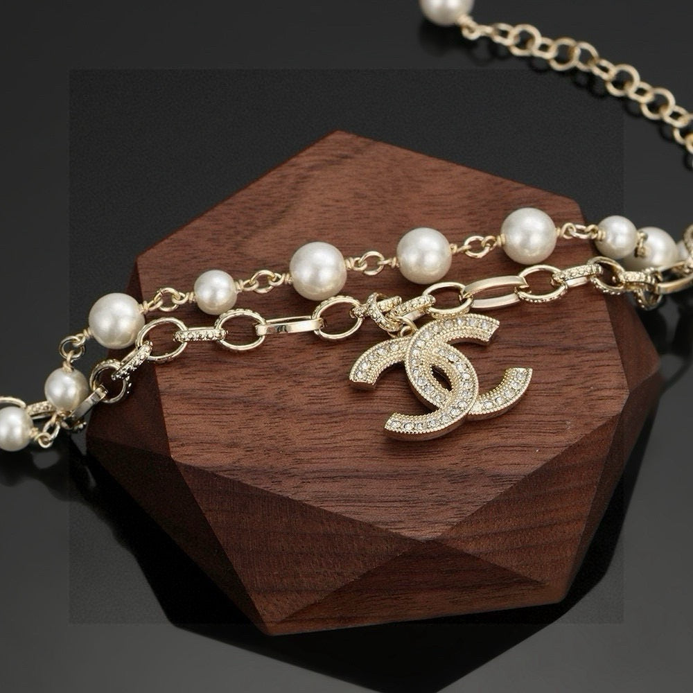 CHANEL - A FAUX PEARL CC BRACELET