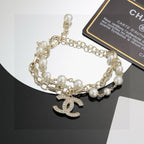 CHANEL - A FAUX PEARL CC BRACELET