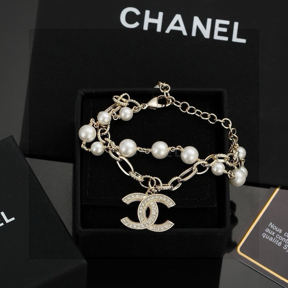 CHANEL - A FAUX PEARL CC BRACELET