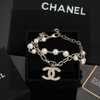 CHANEL - A FAUX PEARL CC BRACELET